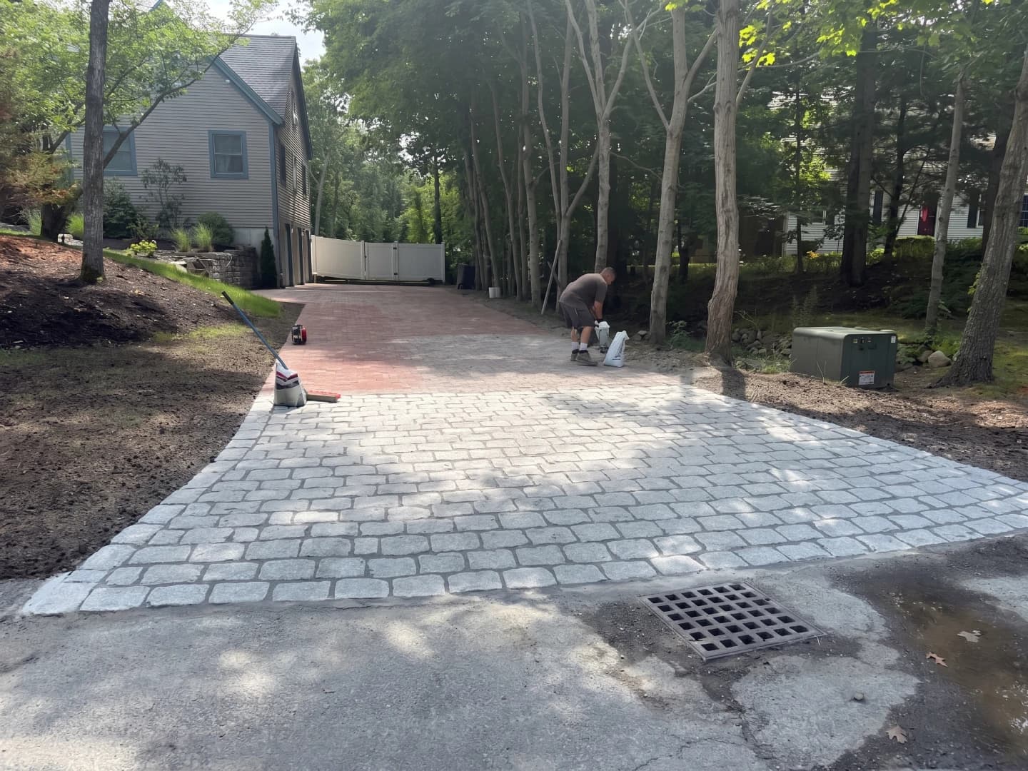 Blu 60 paver installation in progress on driveway expansion